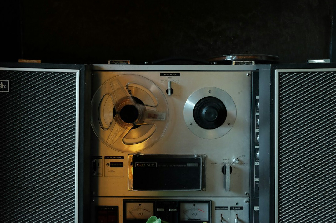 Analogue video editing suite with monitors, mixing desk and tape reels