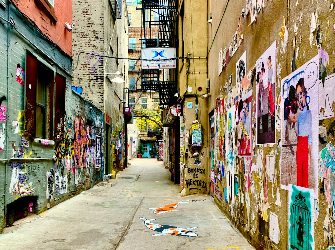 Wall covered with layered vintage advertising posters in a city alley